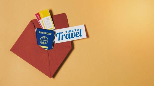 A red envelope with a passport, travel tickets, and a card saying 'Time to Travel'. 